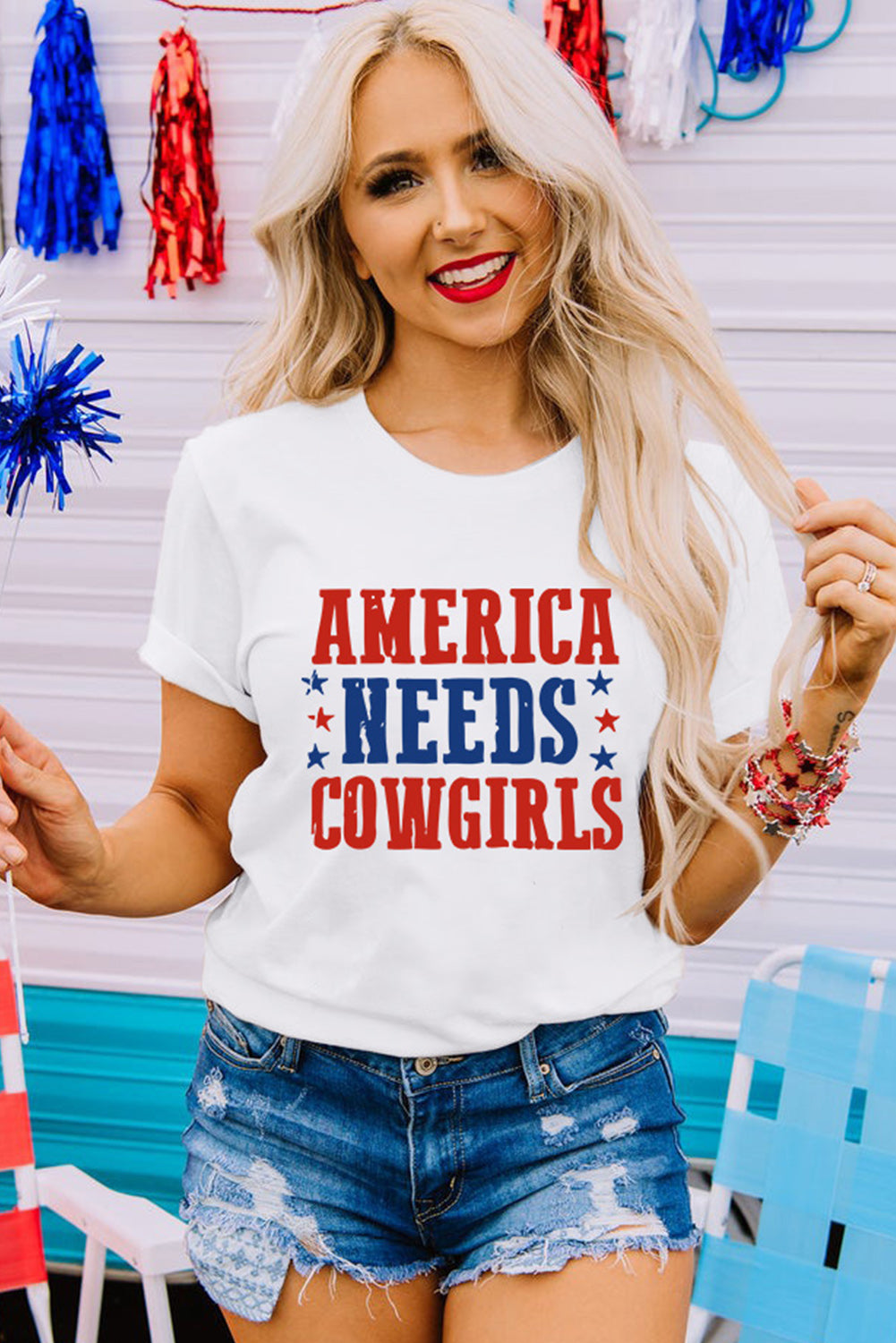 a woman wearing a white t - shirt that says america needs cowgirls