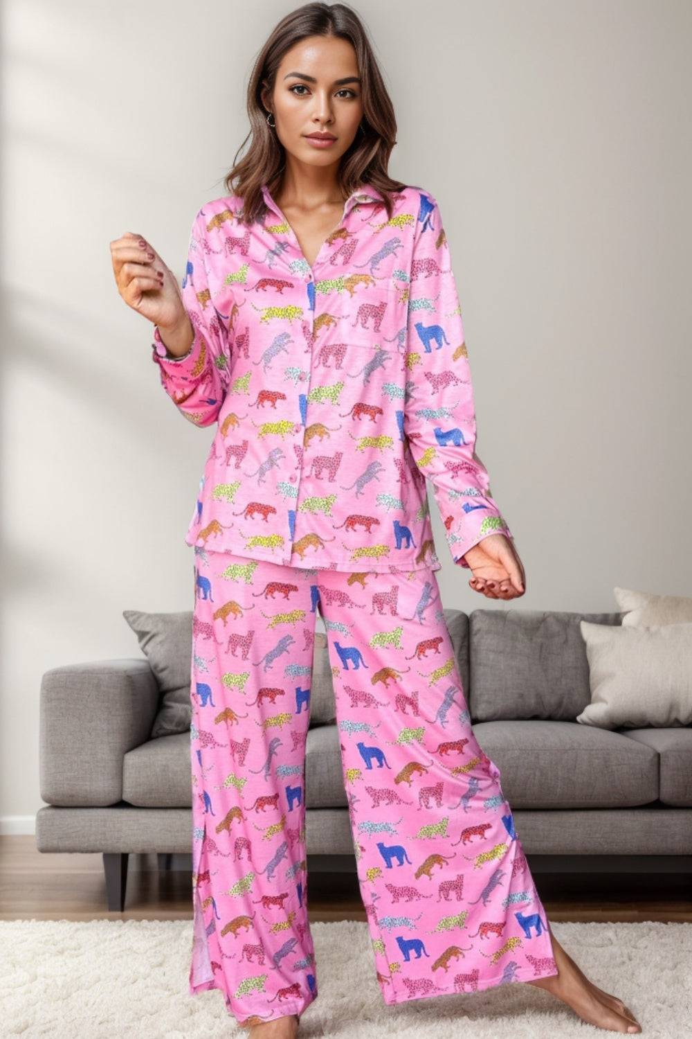 a woman in pink pajamas standing in front of a couch