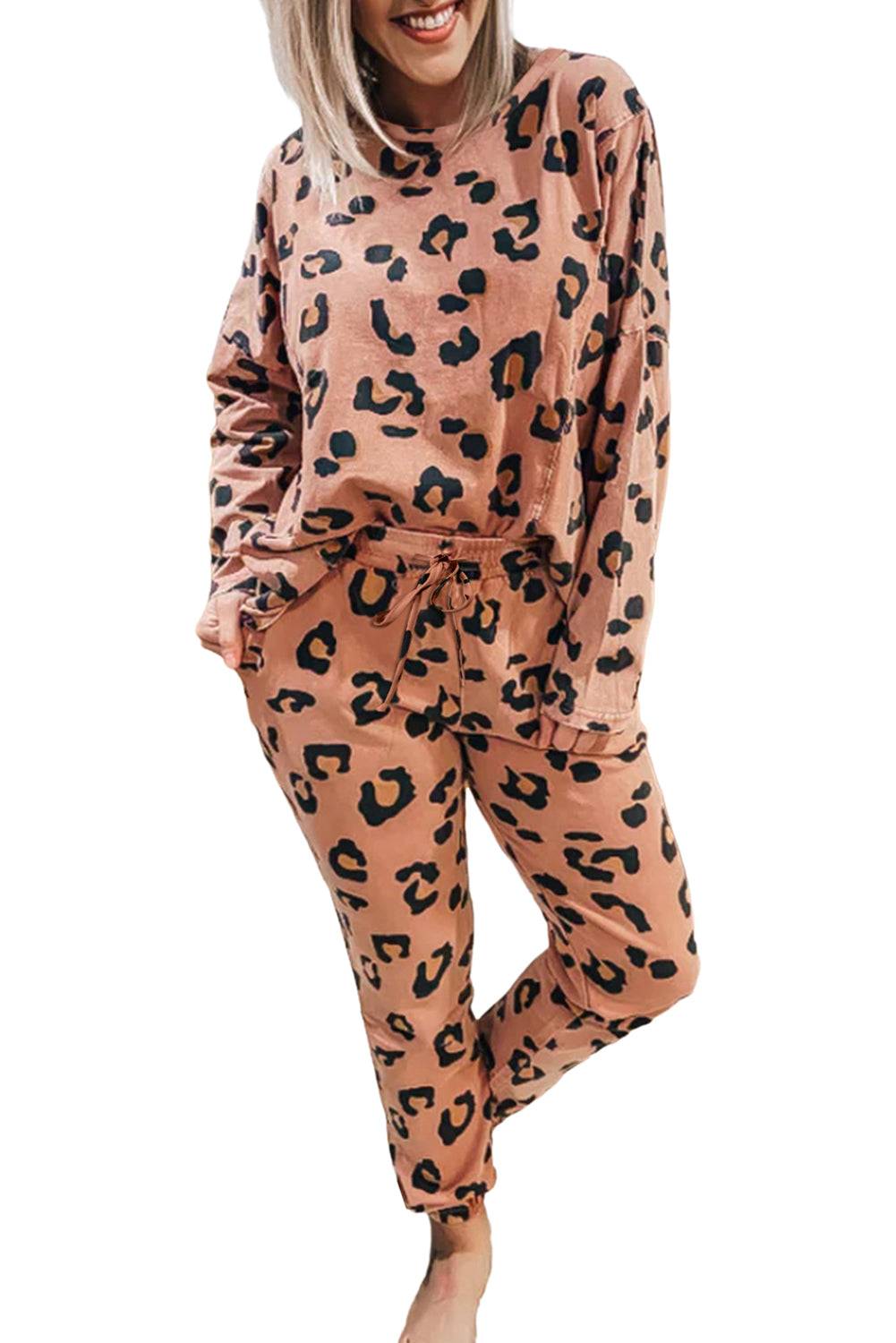 a woman wearing a pink and black leopard print pajama set