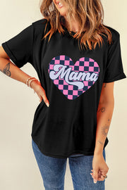 a woman wearing a black t - shirt with a pink heart and the word mama