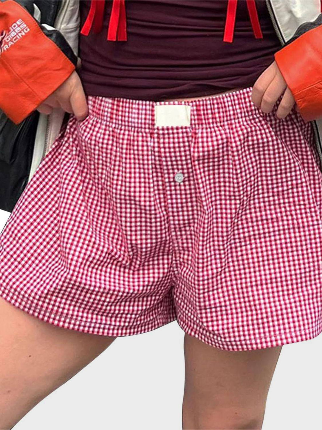 a person wearing a red and white checkered boxer shorts
