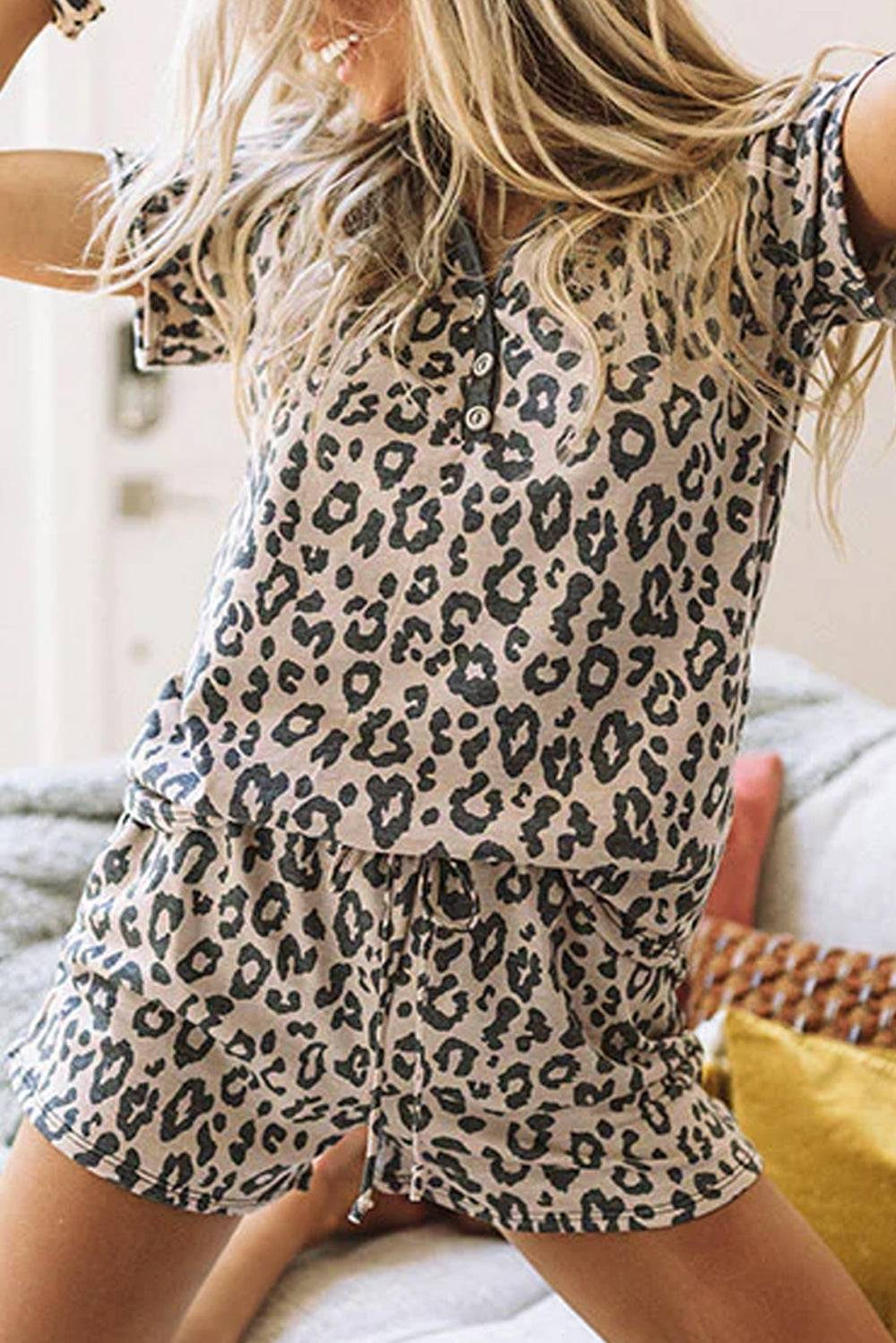 a woman in a leopard print shirt and shorts on a bed