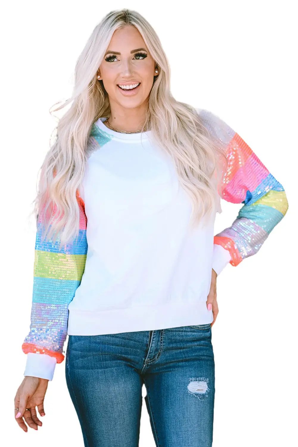 a woman with blonde hair wearing a white sweater and ripped jeans