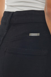 a close up of a person wearing black pants