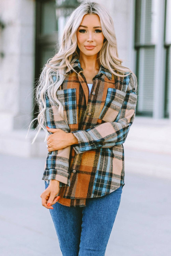 a woman wearing a plaid shirt and jeans