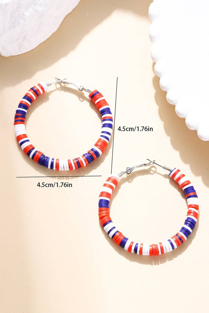 a pair of red, white, and blue beaded hoop earrings