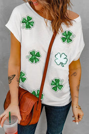 a woman holding a drink and wearing a st patrick's day shirt
