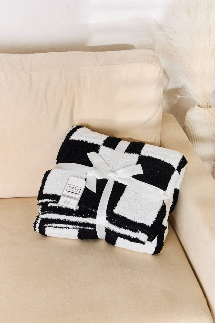 a black and white blanket on a couch