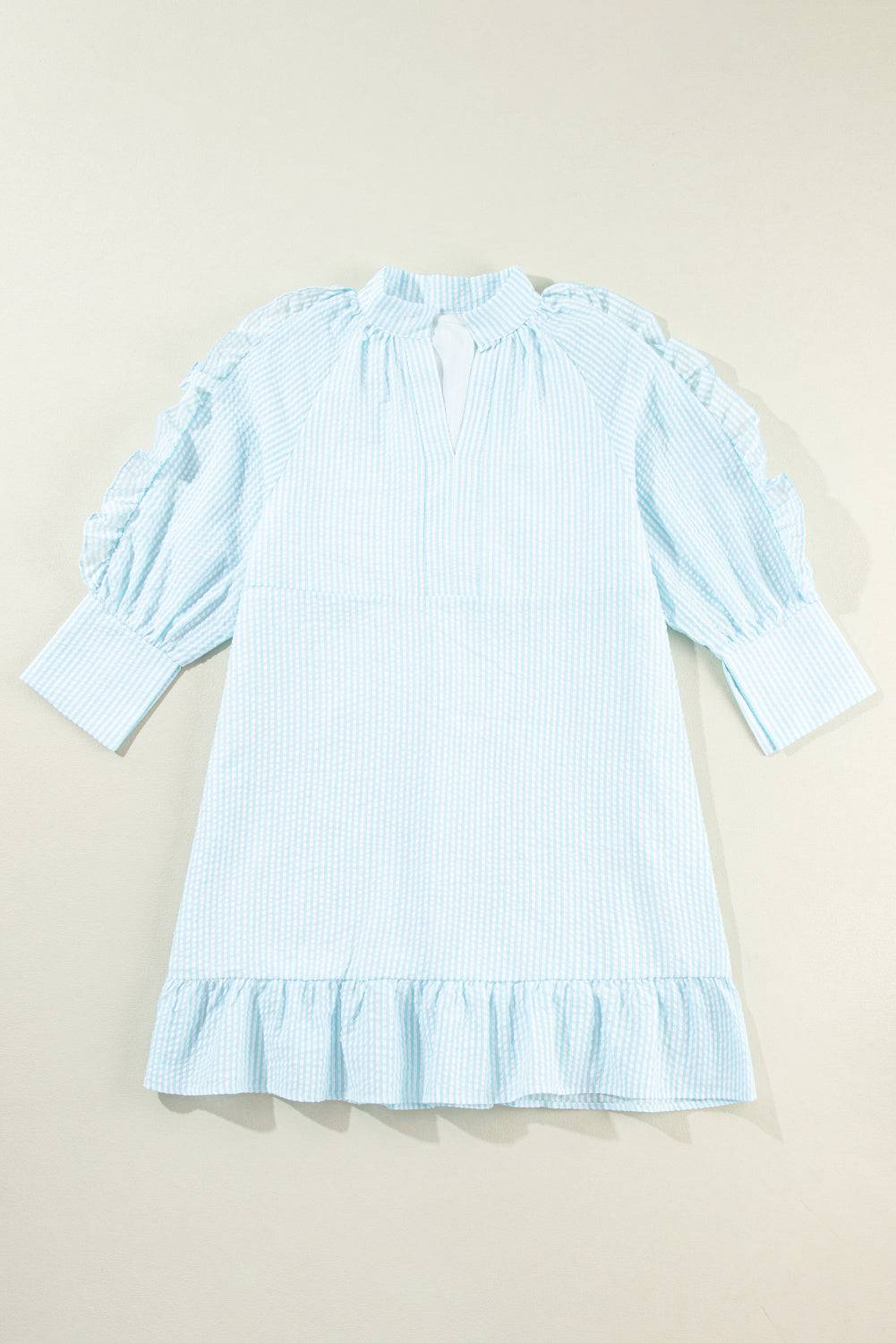 a little girl's blue and white dress with ruffles