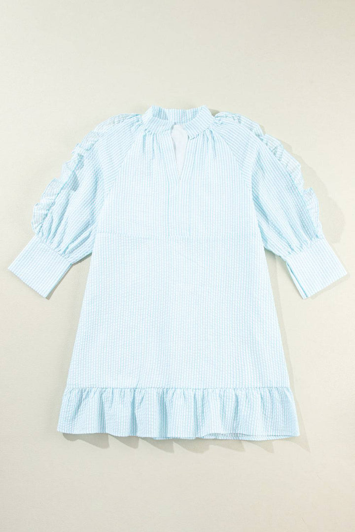 a little girl's blue and white dress with ruffles