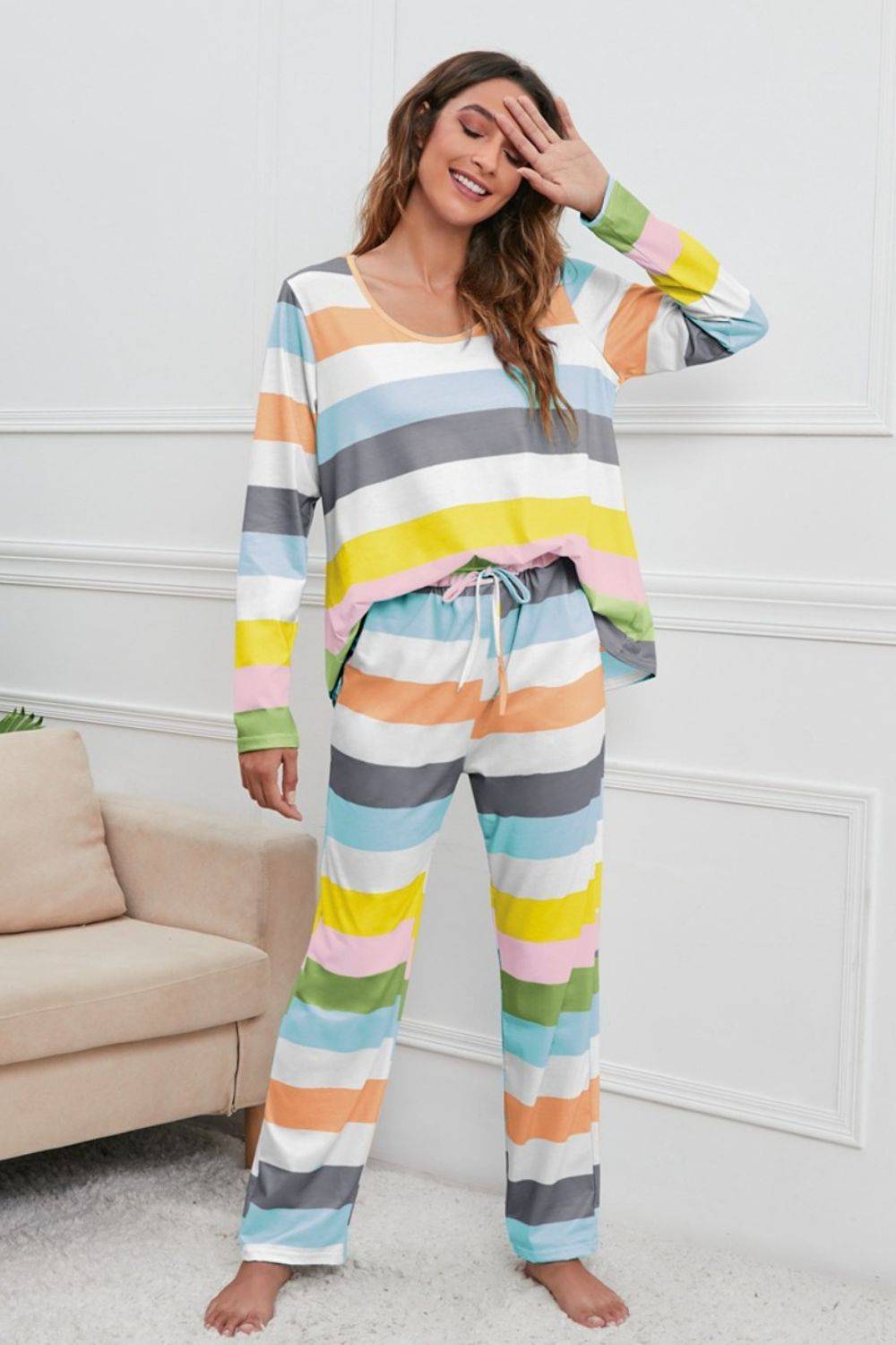 a woman wearing a colorful striped pajama set