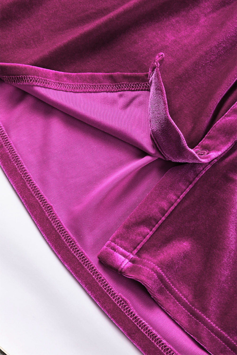 a close up of a purple cloth on a white surface