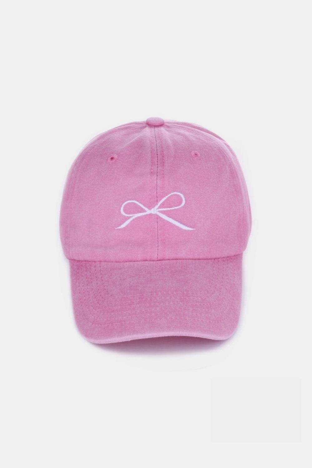 a pink hat with a white bow on it