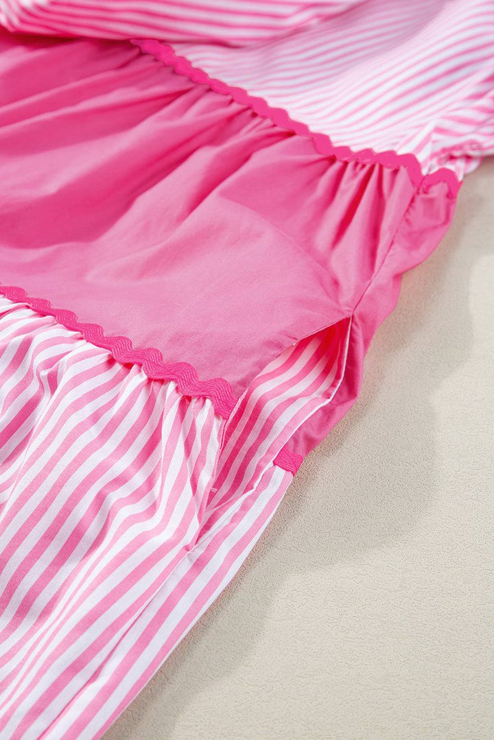 a pink and white striped bed spread with ruffled edges