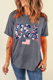 a woman wearing a usa t - shirt and jeans