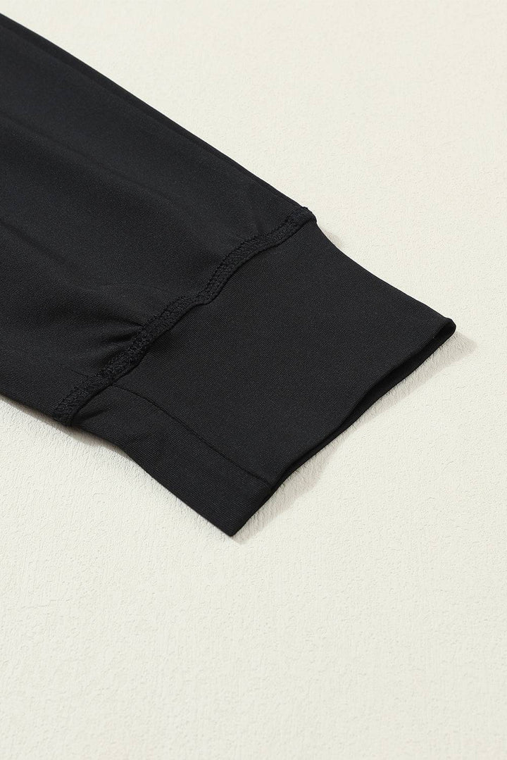 a close up of a black pants on a white surface