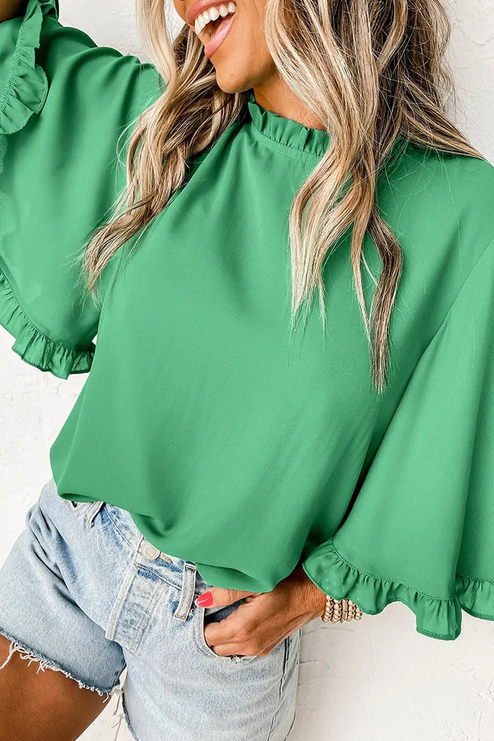 Green Frilly Round Neck Wide Half Sleeve Blouse styled with denim shorts, perfect for summer fashion at Faith & Co. Boutique.