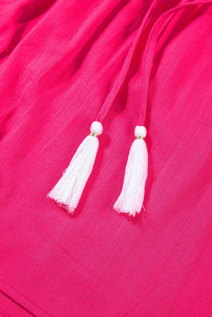 a pair of tassels on a pink dress