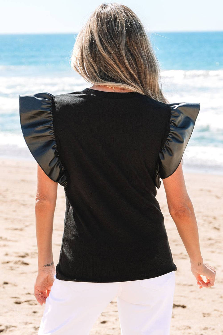 Back view of Black Leather Ruffle Sleeve Patchwork Round Neck Blouse showing ruffled faux leather detail, available at Faith & Co. Boutique.