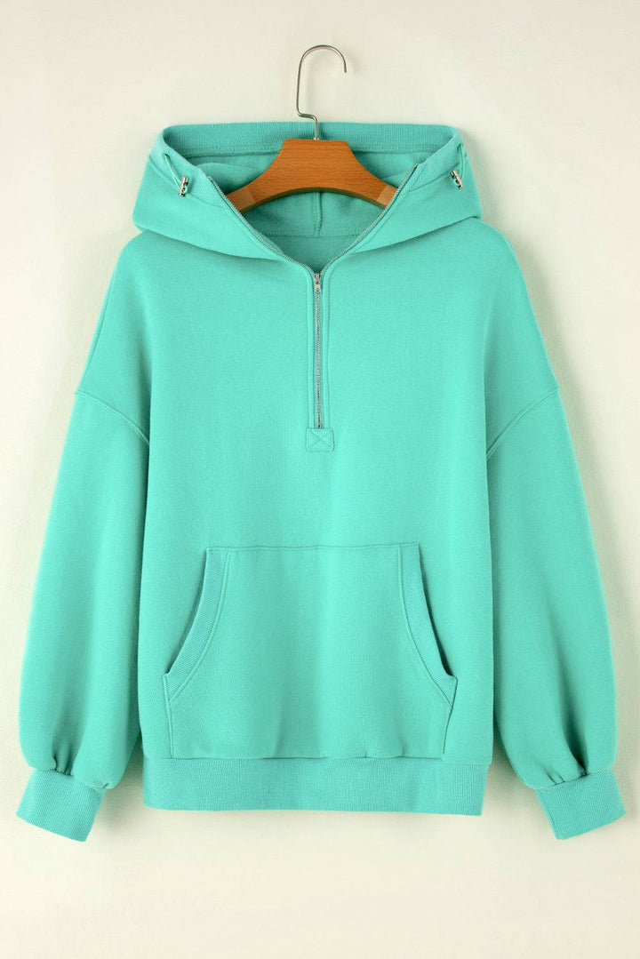 a green hoodie hanging on a hanger