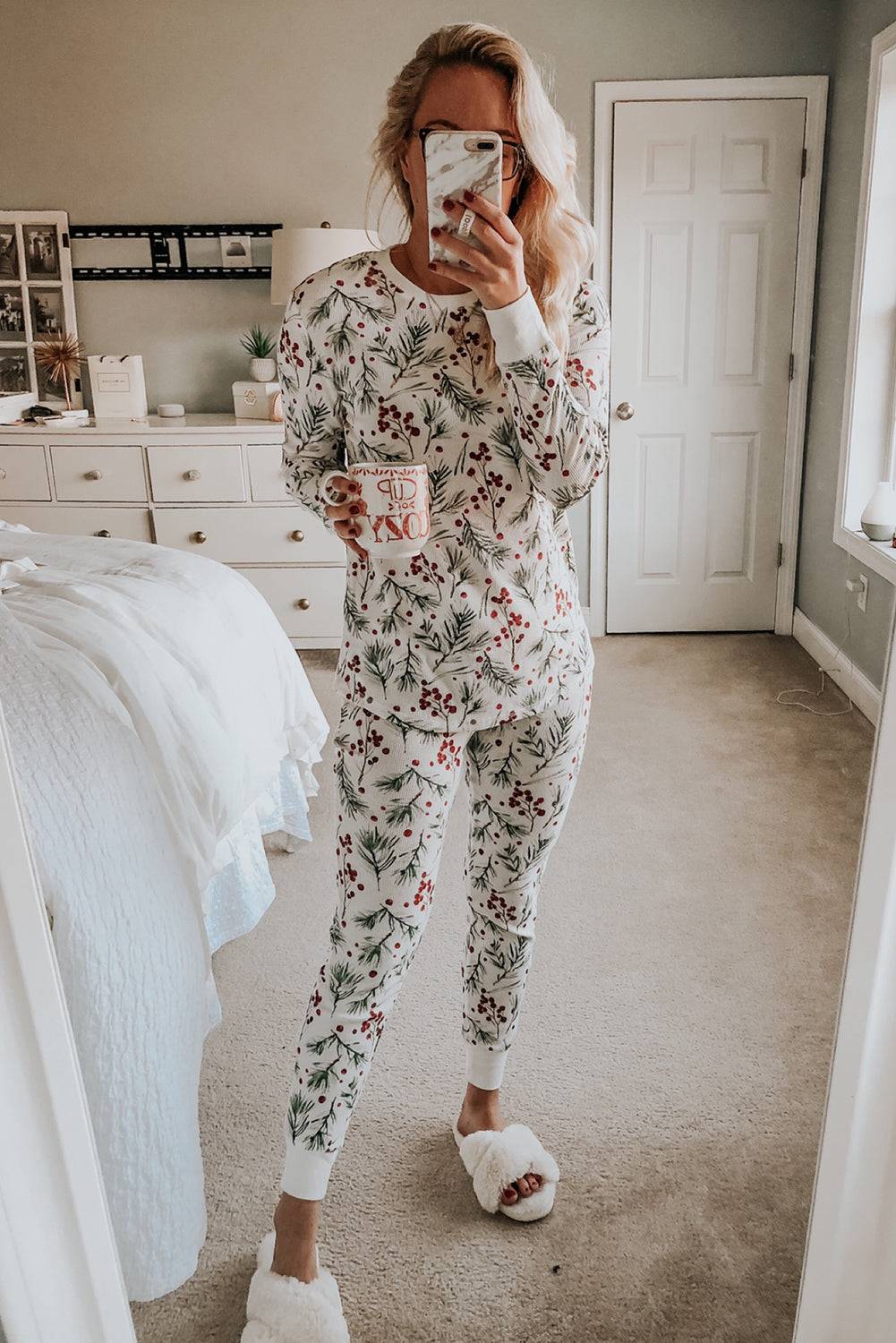 a woman taking a picture of herself in her pajamas