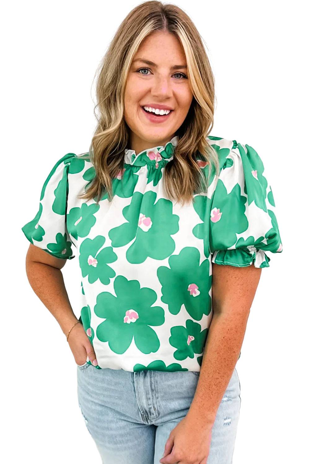 a woman wearing a green and white top with flowers on it