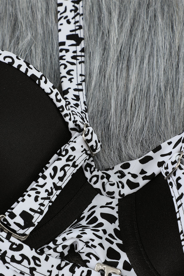 a close up of a black and white animal print purse