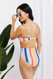 a woman in a bikini top and sunglasses