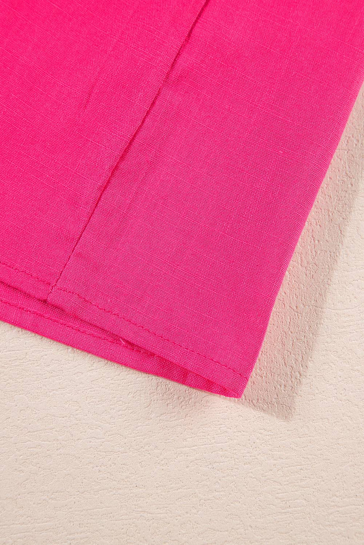 a close up of a pink material on a white surface