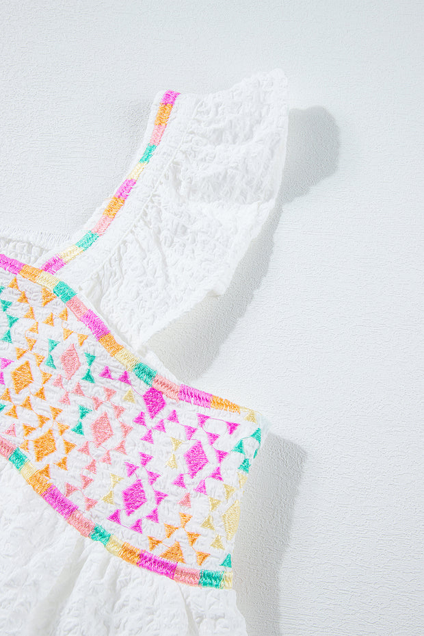 a crocheted dress is laying on a white surface