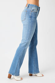 a woman in high rise jeans with her legs crossed