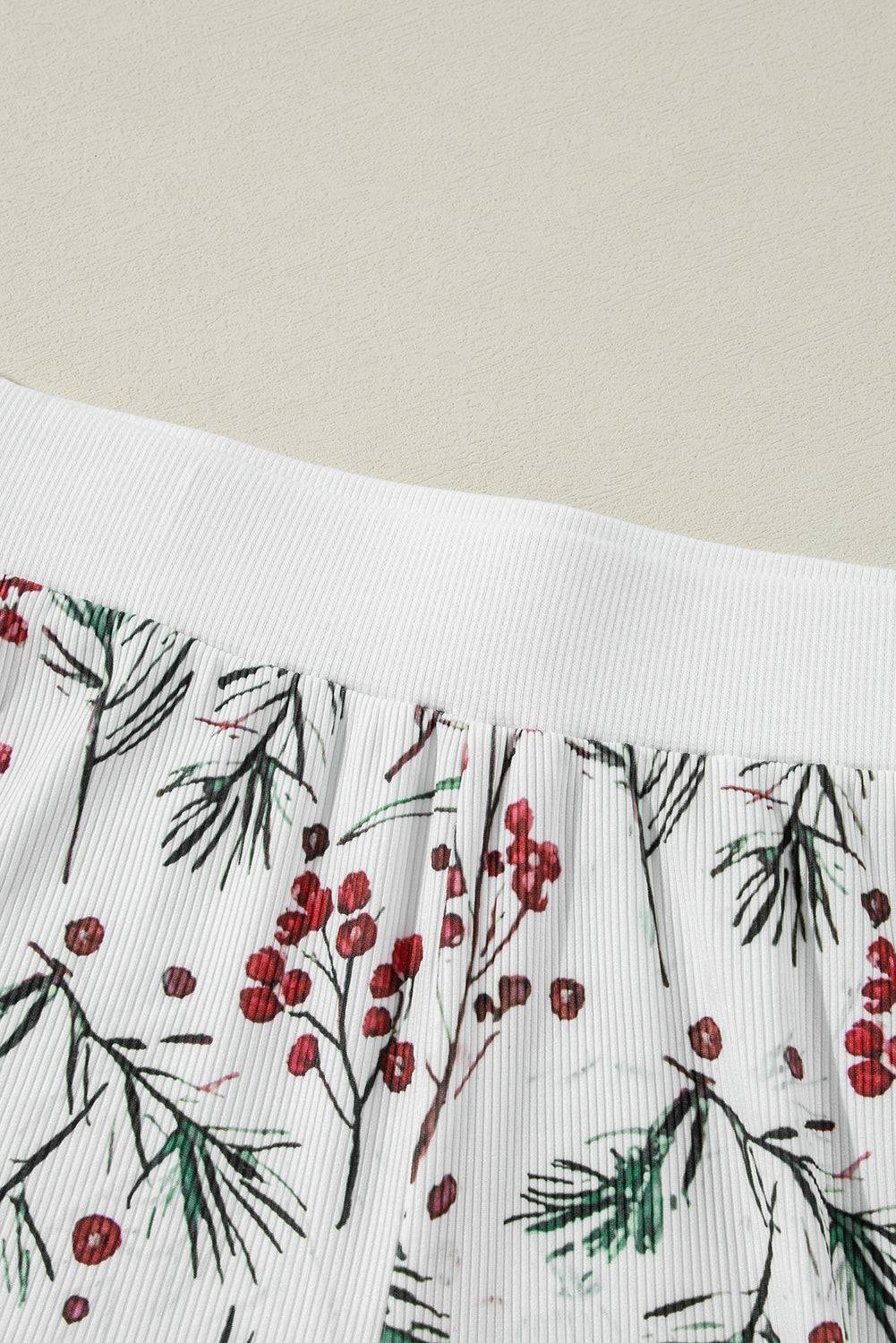 a close up of a piece of cloth with red berries on it