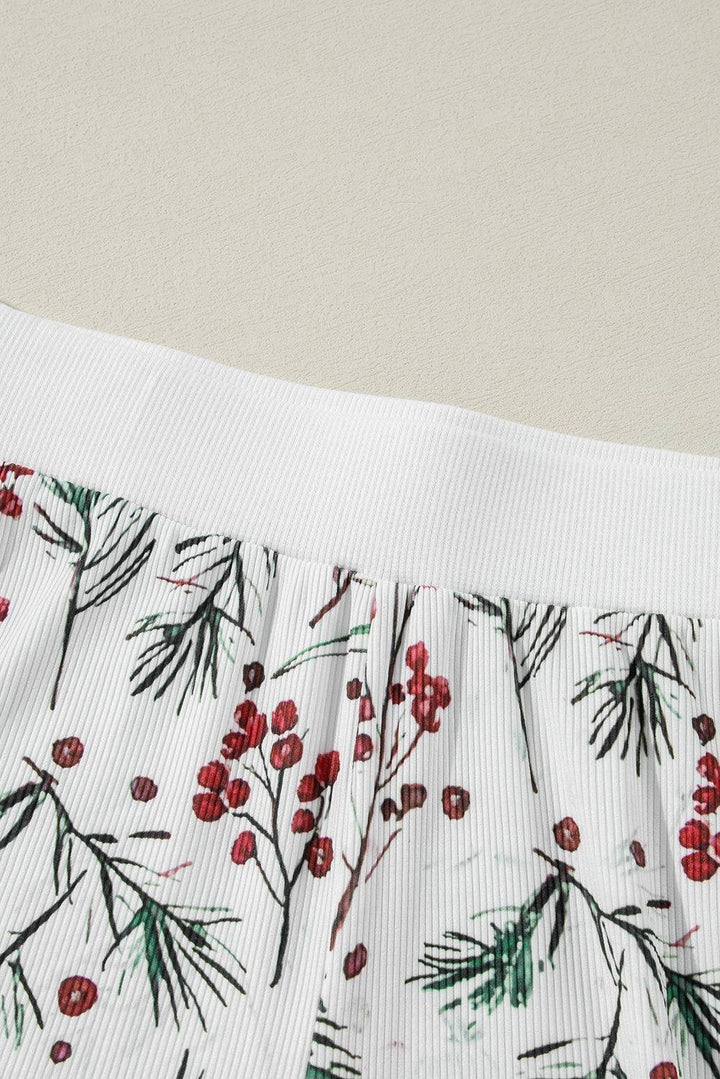 a close up of a piece of cloth with red berries on it