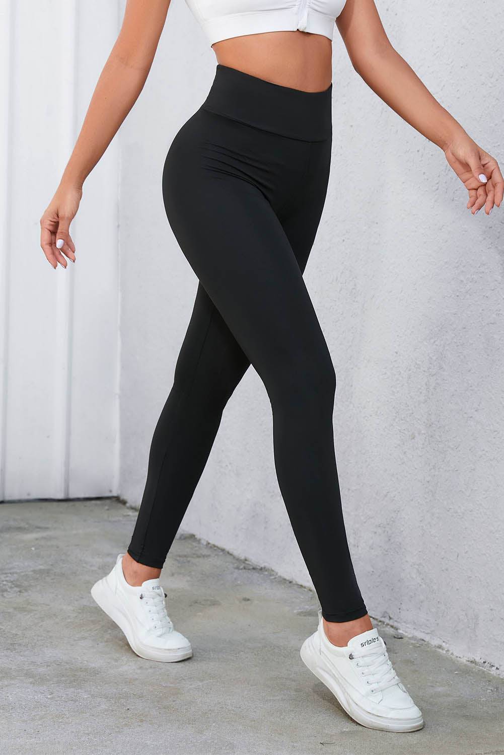 a woman in a white crop top and black leggings