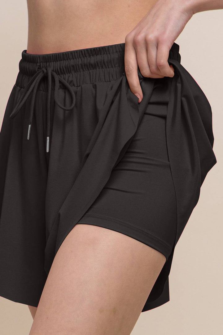 a close up of a person wearing a black shorts