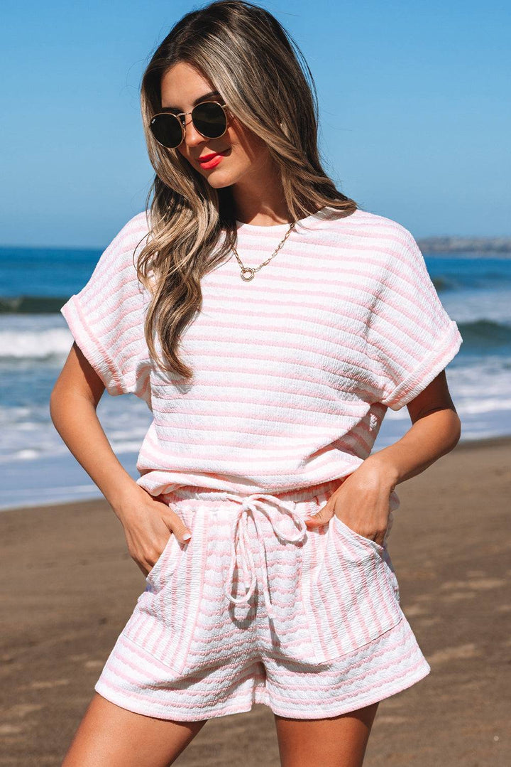 Pink Stripe Knitted Short Sleeve Top and Drawstring Shorts Set with front pockets, styled for a sunny beach day.