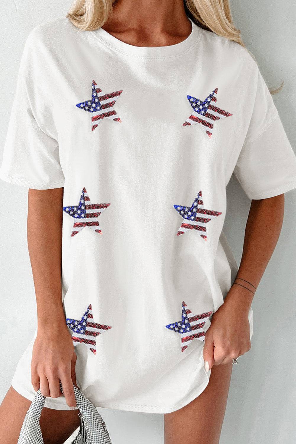 a woman wearing a white t - shirt with american flags on it