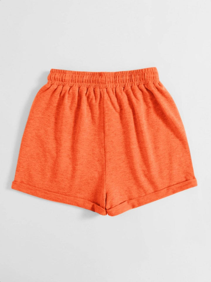 a pair of orange shorts on a white background
