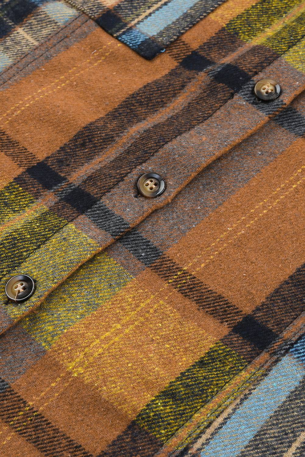 a close up of a plaid shirt with buttons