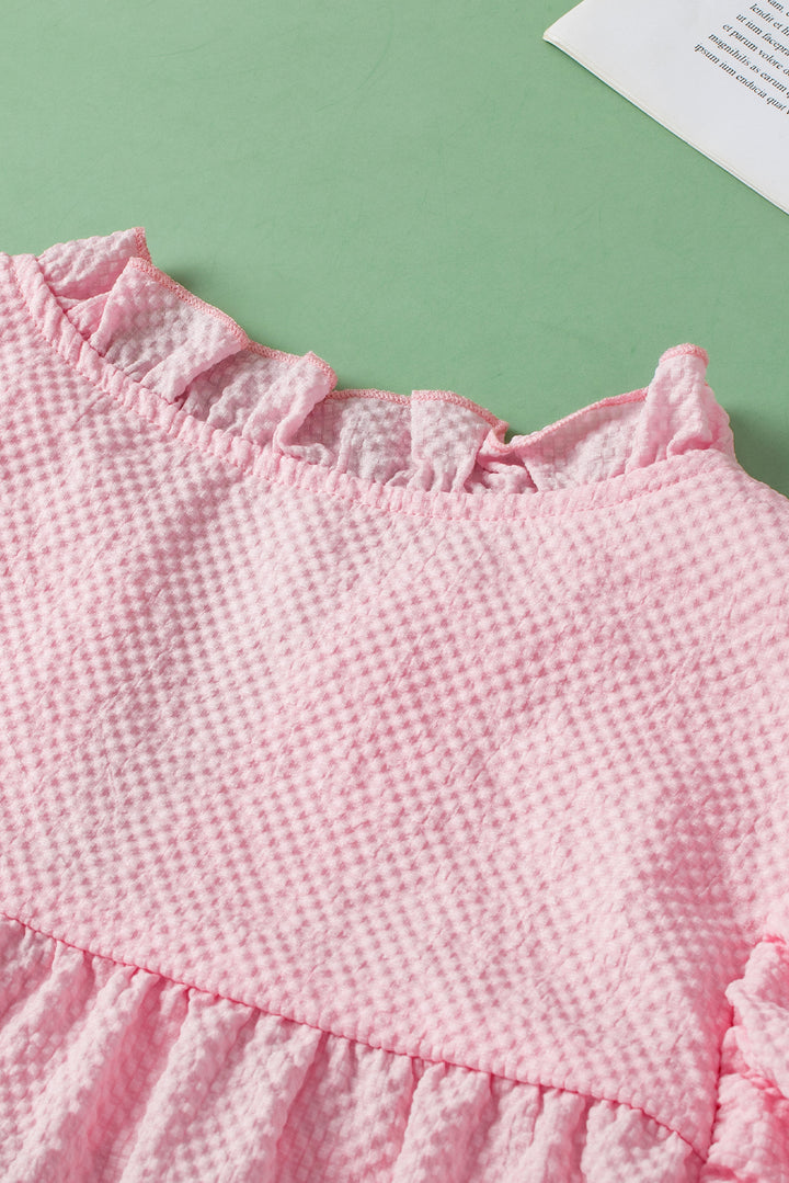 a close up of a pink dress on a table