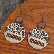 a pair of leopard print earrings with the word mama on them