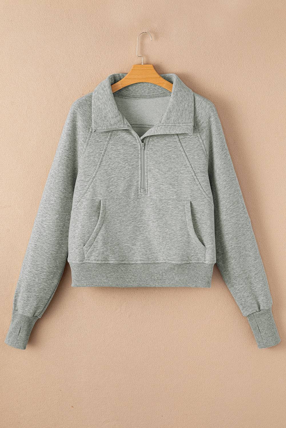 a gray sweatshirt hanging on a hanger