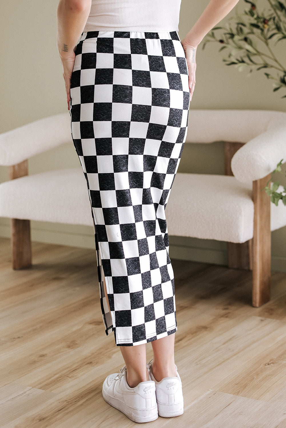 Back indoor view of White Checkered Print Midi Skirt, highlighting the high waist and flattering fit for everyday wear.