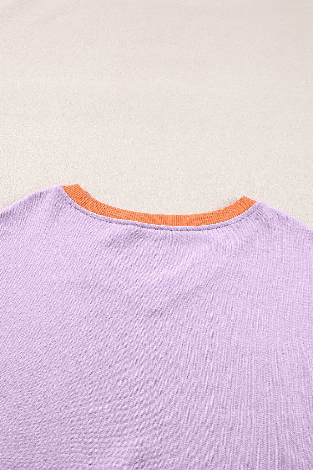 a close up of a purple shirt with an orange stripe