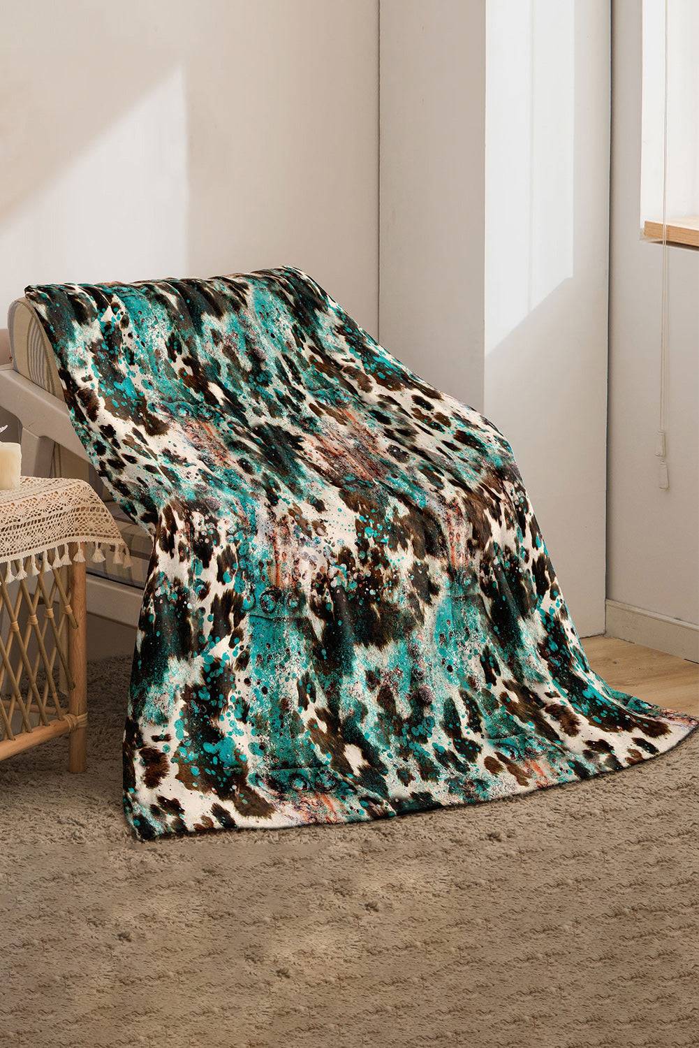 a leopard print blanket sitting on top of a rug