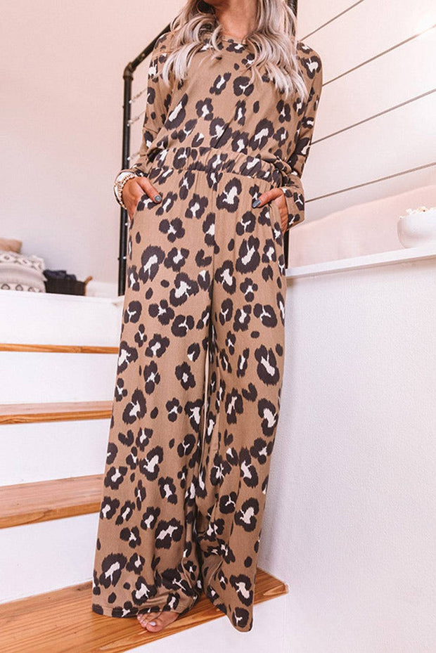 a woman in a leopard print jumpsuit standing on a staircase
