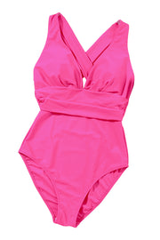 a pink one piece swimsuit on a white background
