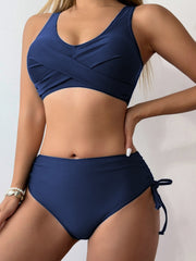 a woman in a blue bikini top and bottom