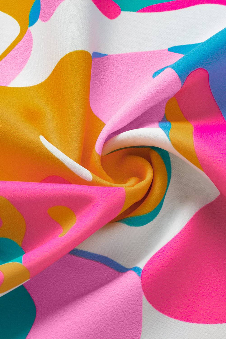 a close up of a pink, orange, and blue fabric