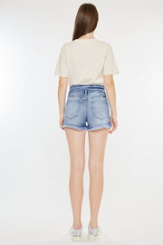 the back of a woman wearing a short jean shorts